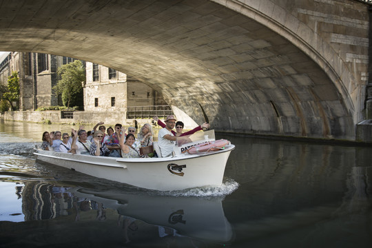 Several people enjoy a boat ride in Ghent