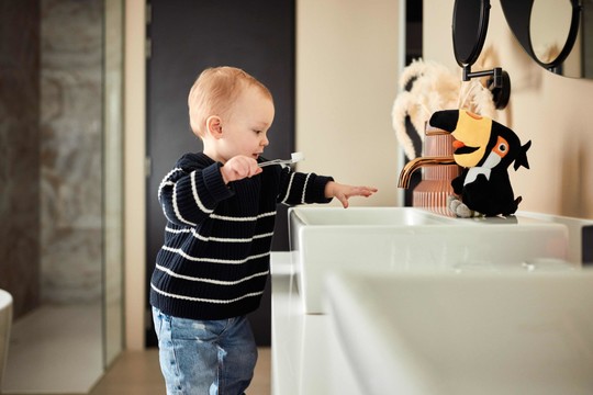 Child on steps at sink