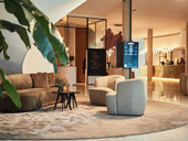 Lobby Van der Valk Ghent with brown and beige with a black table